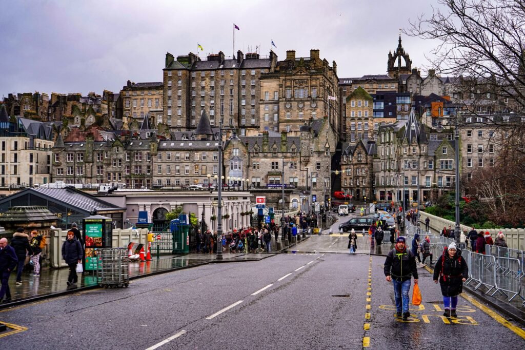 View of a busy street in Edinburgh showcasing historic architecture and urban life.