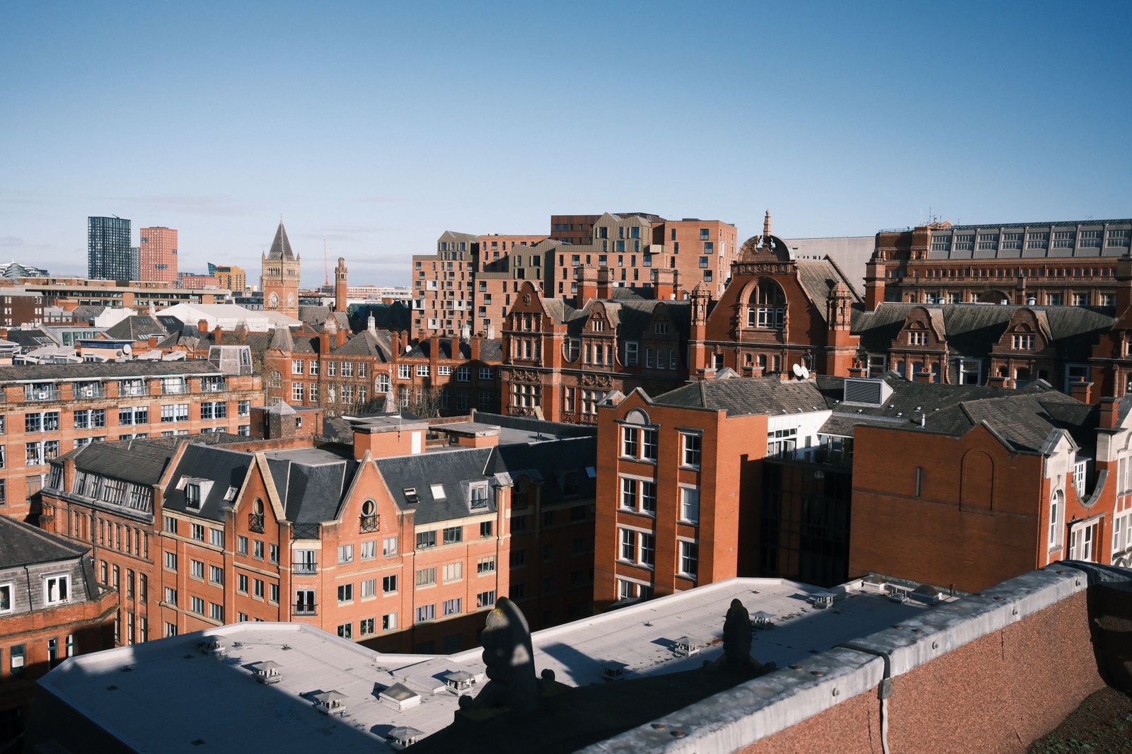 Aerial photo capturing Manchester's historic cityscape with classic red brick buildings.
