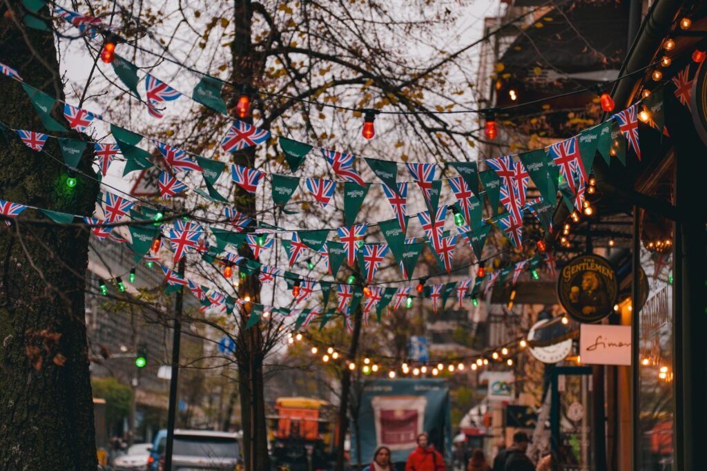 Vibrant street scene with British flag bunting and lights in Kyiv, Ukraine, during fall evening.