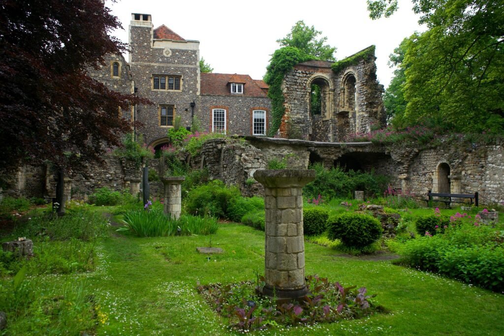 Lush garden with ancient ruins and architecture in Canterbury, England.