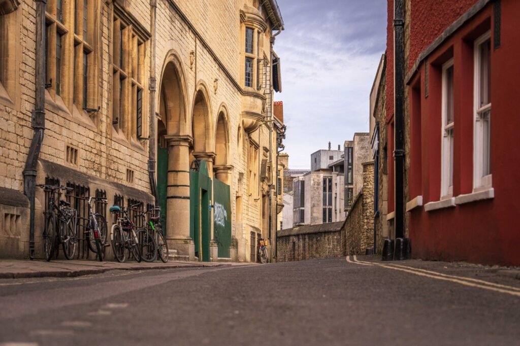 A picturesque cobblestone street in an old town with bicycles lined up against historical buildings.