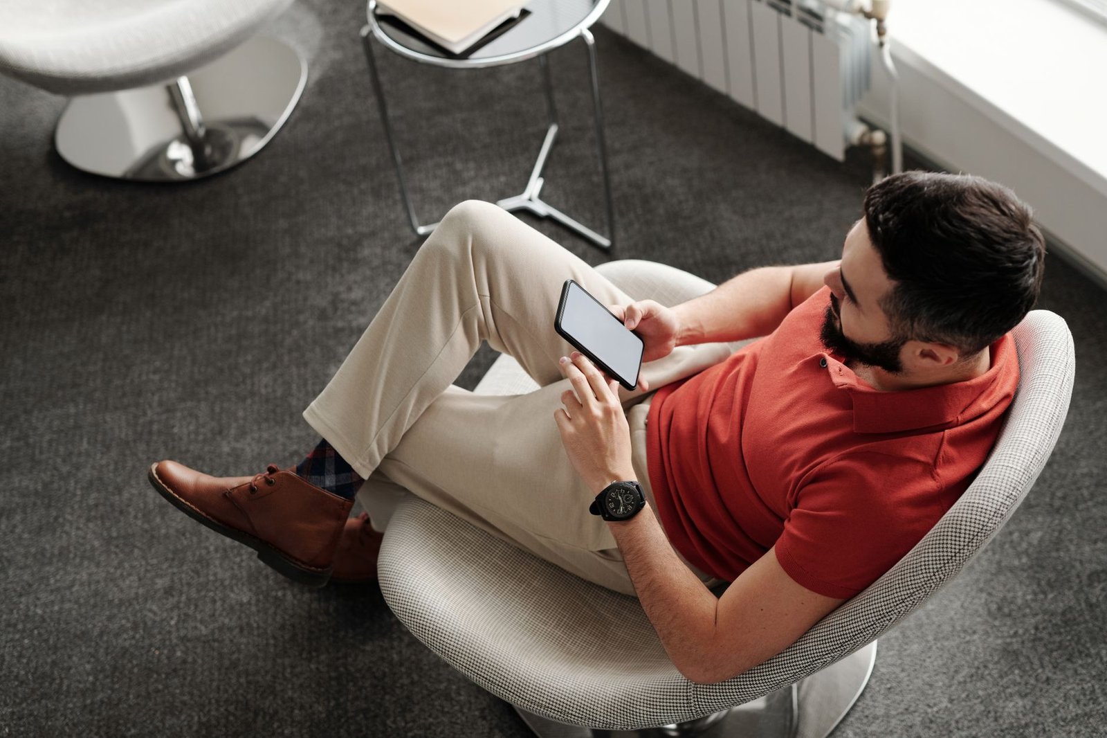 Man checking meeting details on his phone before leaving