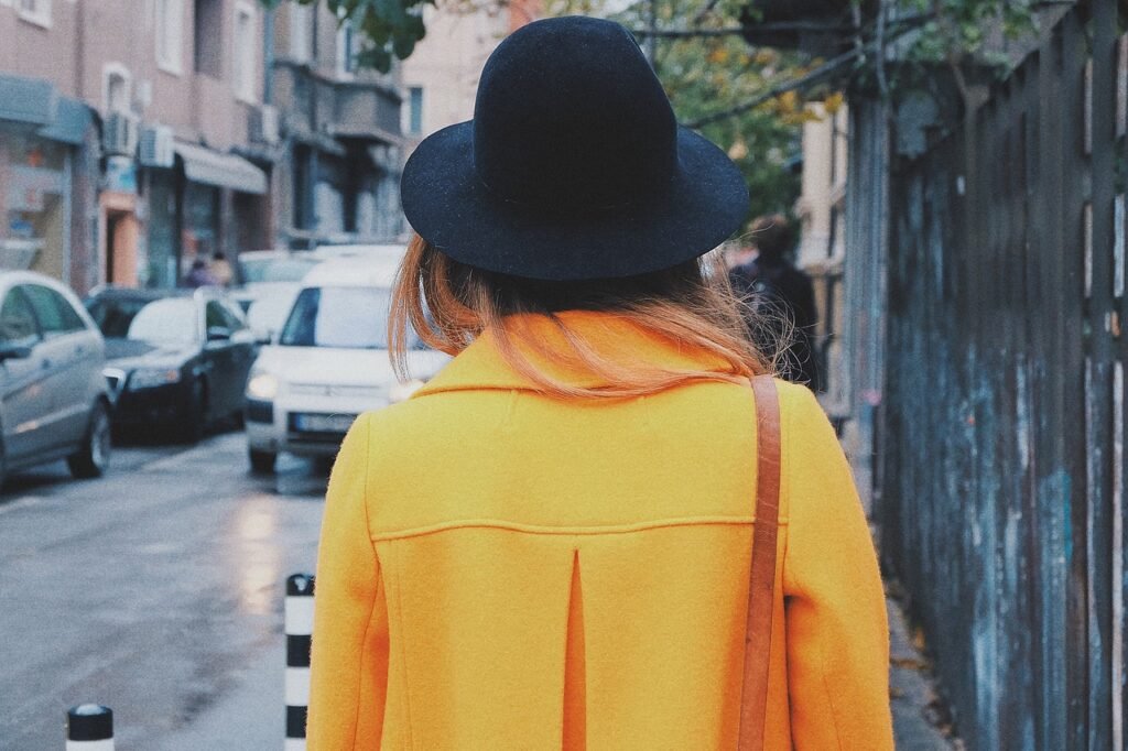 woman, back, hat, coat, yellow coat, trench coat, fashion, style, stylish woman, young, walking, city, urban, female, street,