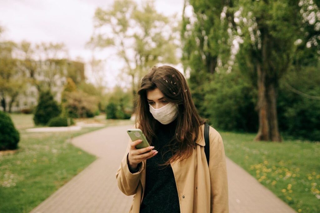 Adult walking through a town centre while keeping in touch
