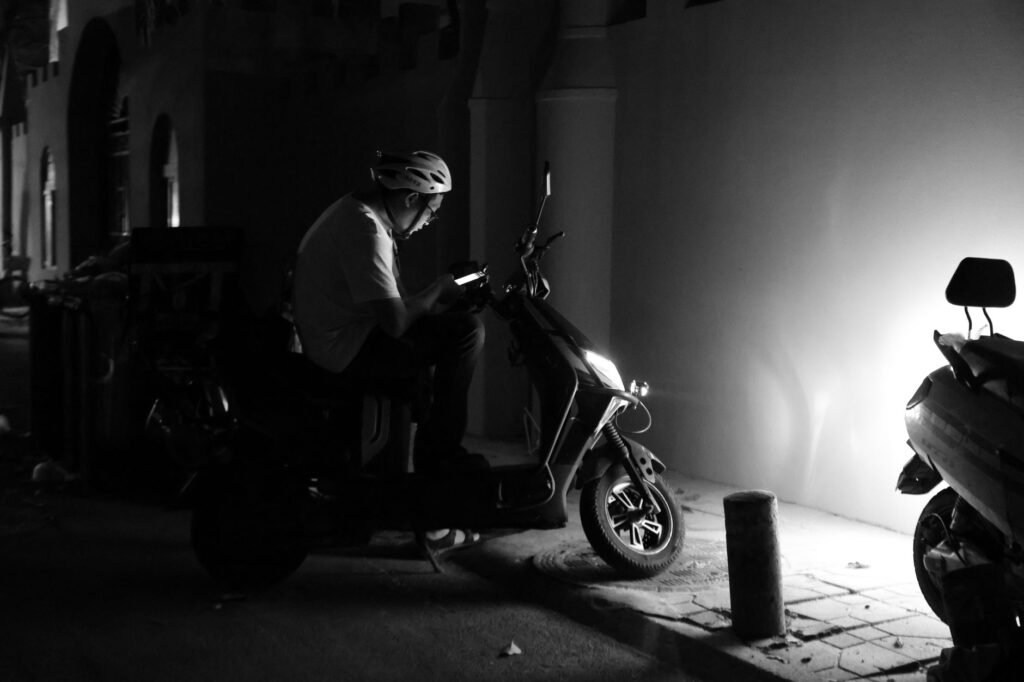Traveller checking a smartphone on a well-lit Bath street