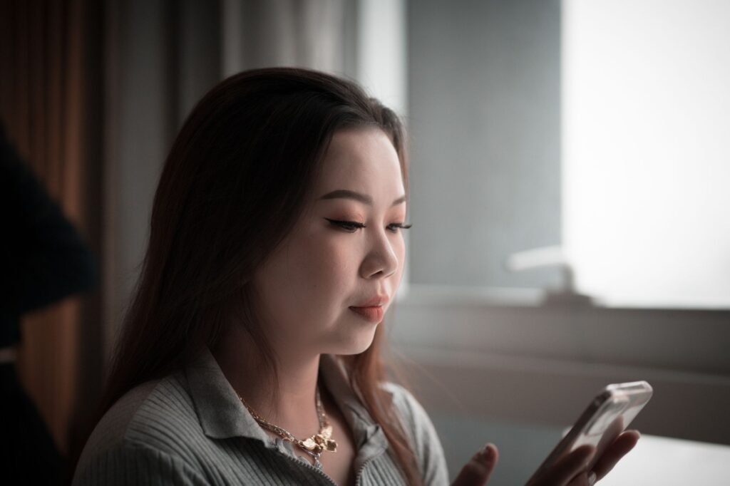 Adult reading an online profile on a smartphone in Bedford