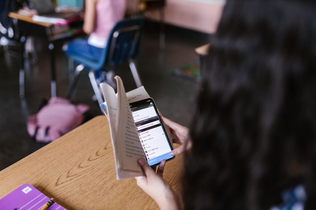 Adult reading information on a smartphone at a desk