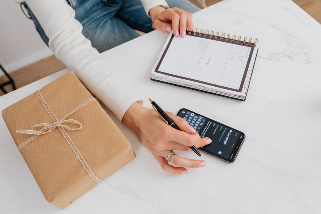 Smartphone and notebook beside a meeting planning checklist