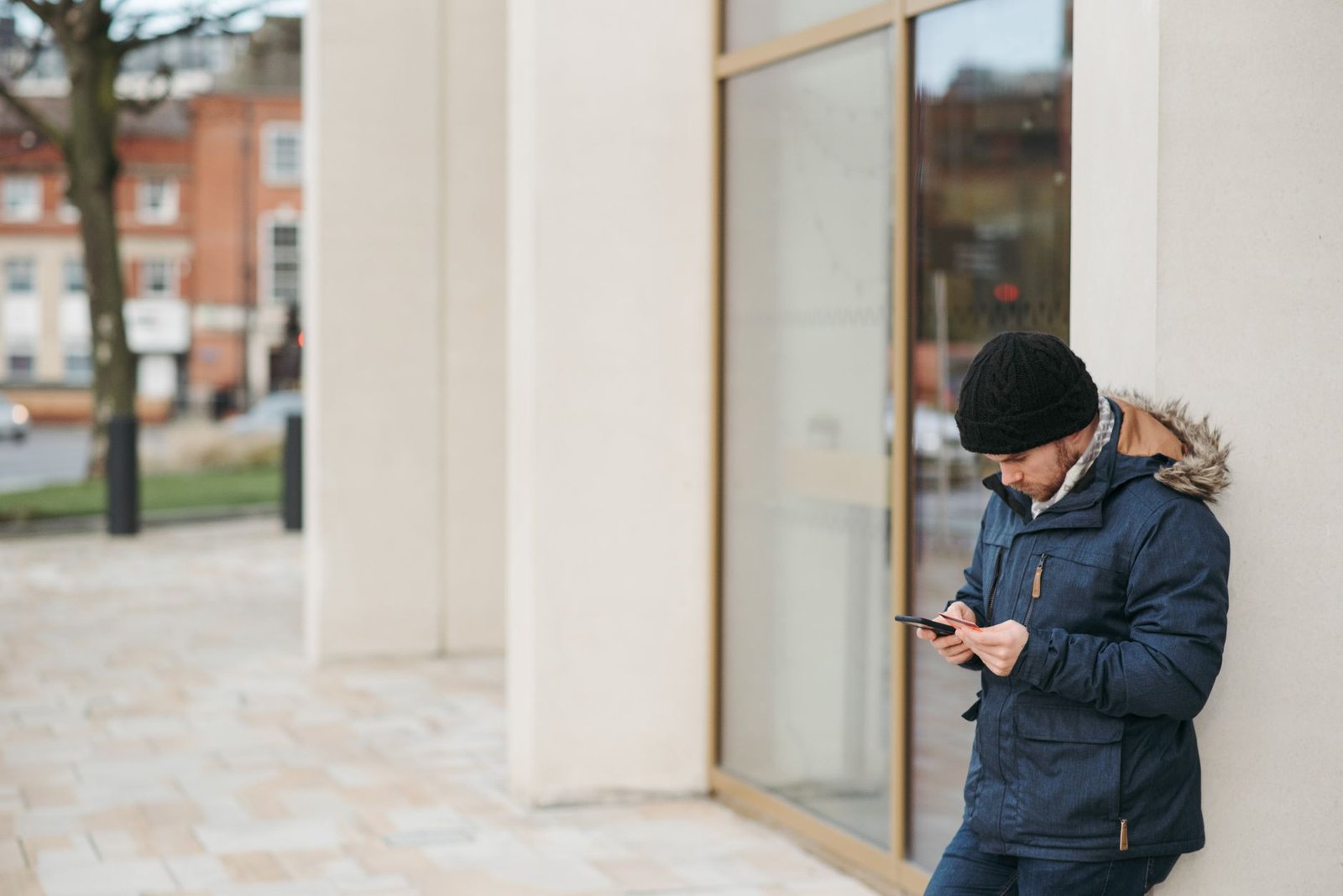 Person discreetly browsing information on a smartphone in Bridgnorth