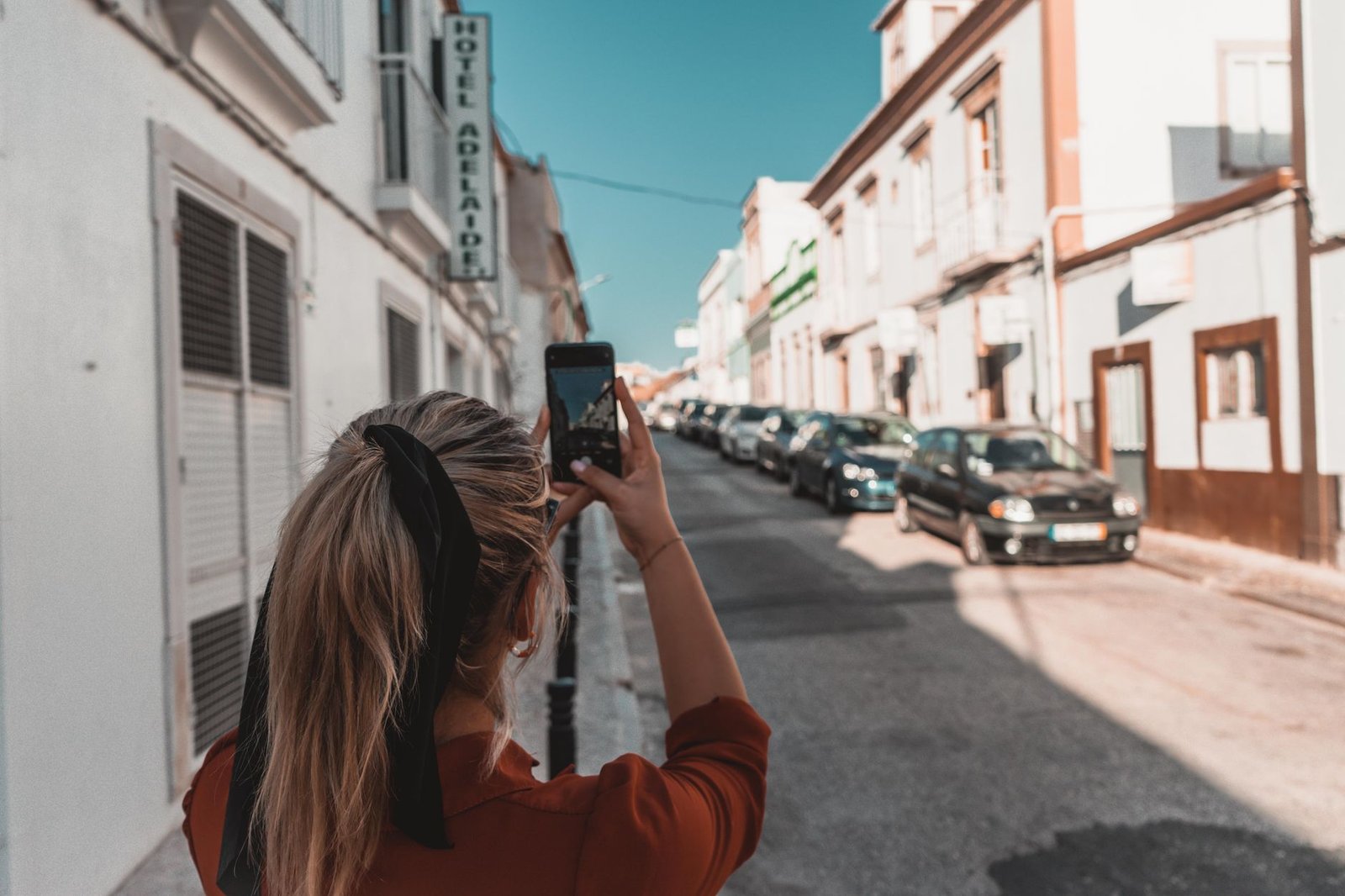 Traveller discreetly planning a visit to Dover with a smartphone and notes