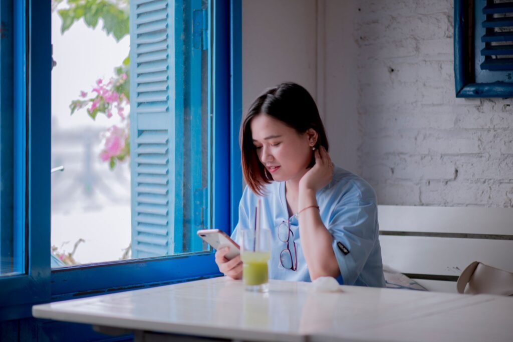 Adult reading an online profile on a smartphone before making an enquiry