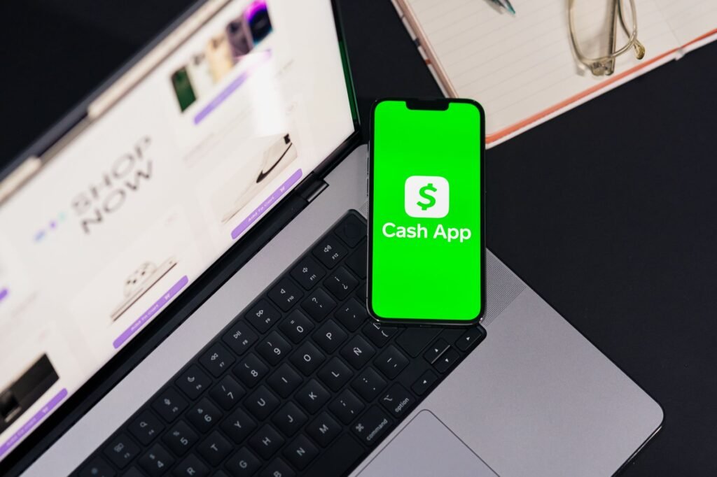 A smartphone and notebook beside a bank card for checking payment details