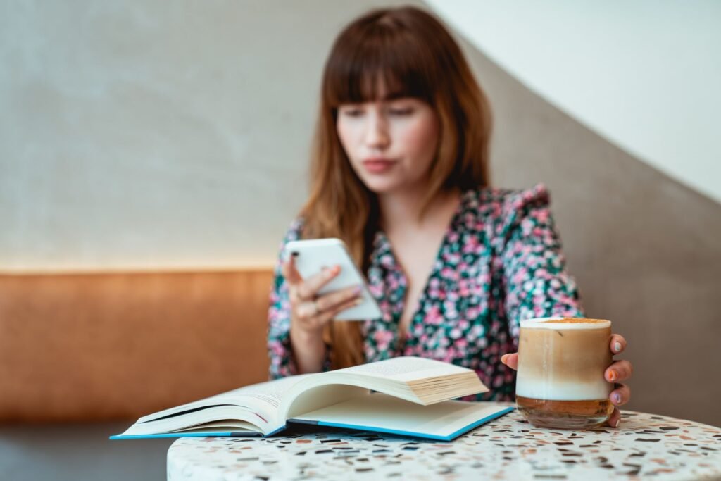 Person reviewing a profile on a smartphone in a quiet café