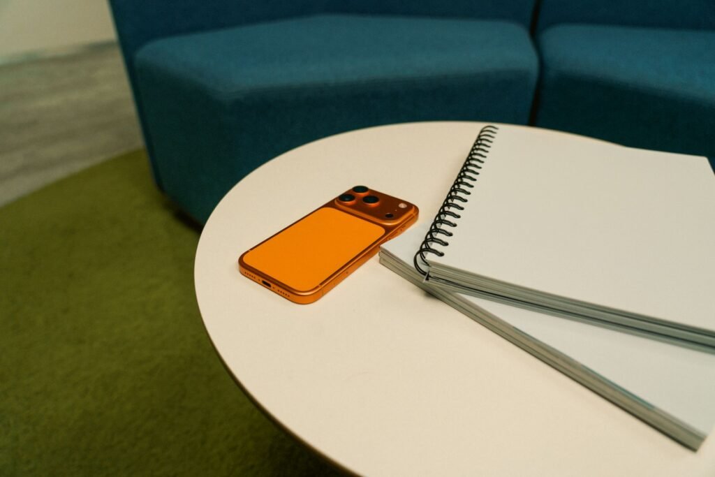 A phone and notebook used to confirm booking details