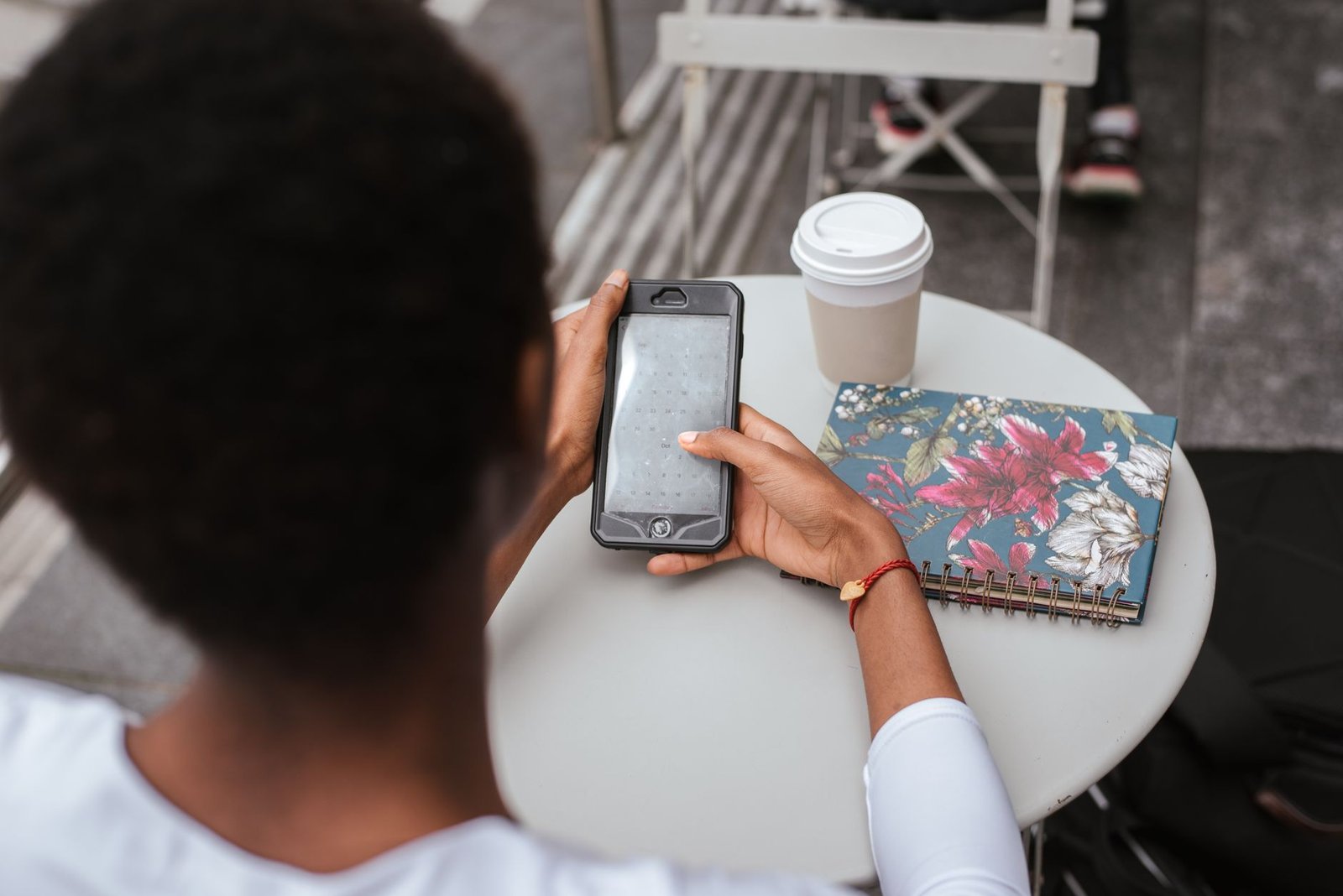 Smartphone and notebook on a café table in Newry