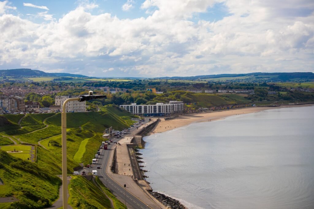 Visitor checking travel details near Scarborough seafront