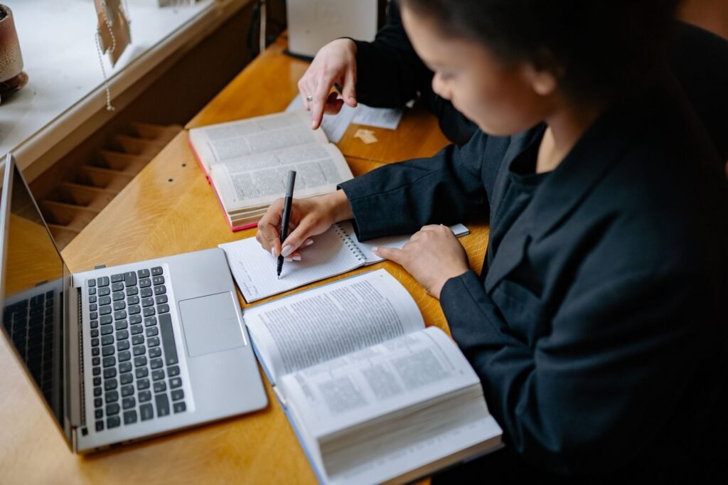 Person reviewing an online profile and making notes