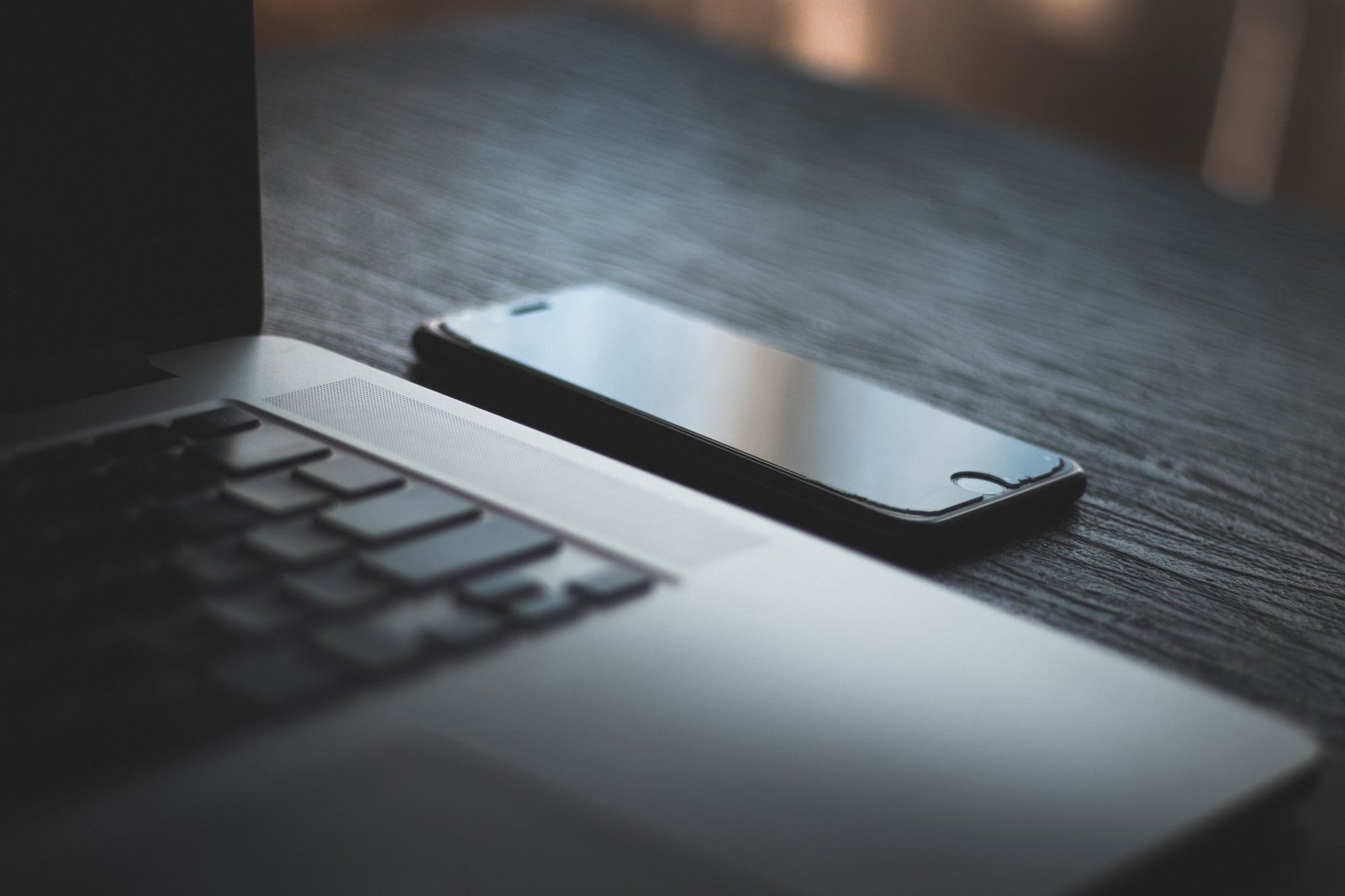 Desk with a laptop and smartphone used for researching a Sheffield directory