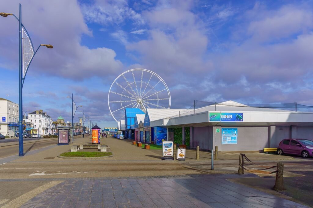 View of the Great Yarmouth seafront with Ferris wheel under clear skies on a sunny day.