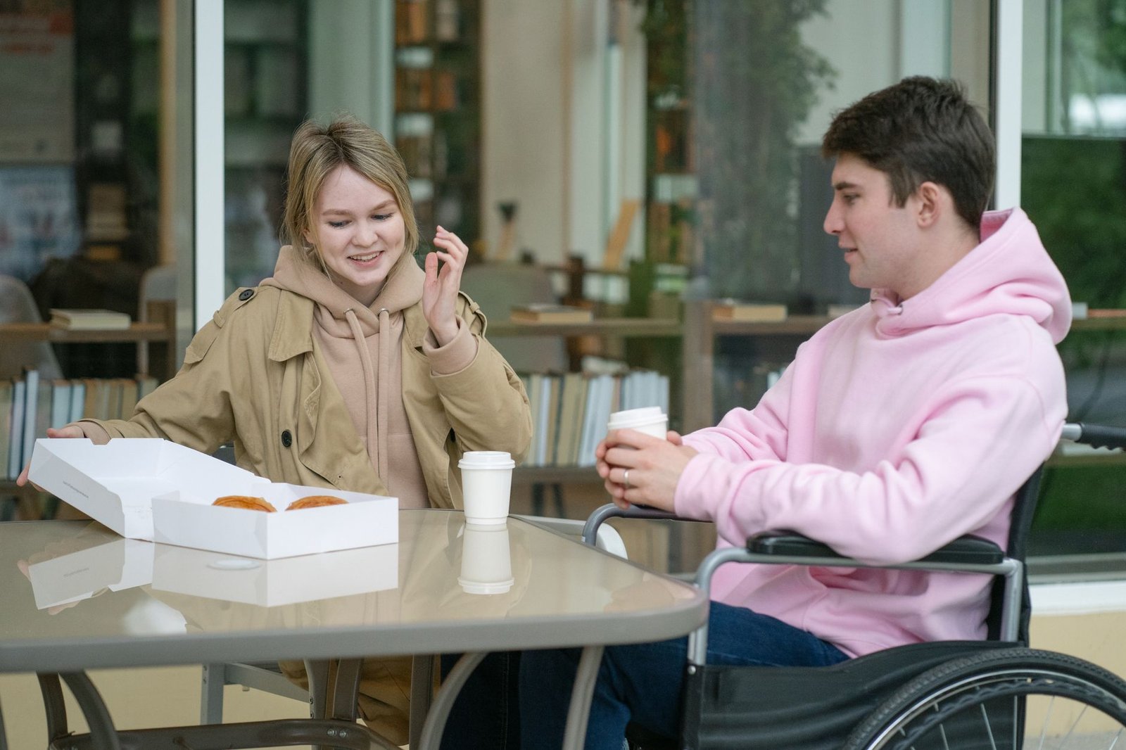 Adults having a relaxed conversation at an accessible café table