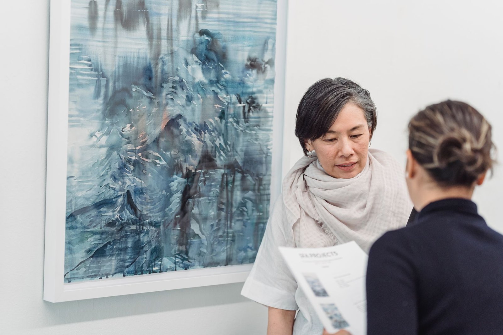 Two adults discussing artwork during a relaxed gallery visit