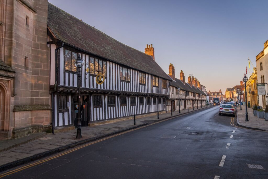 A picturesque street showcasing Tudor-style architecture during the day.