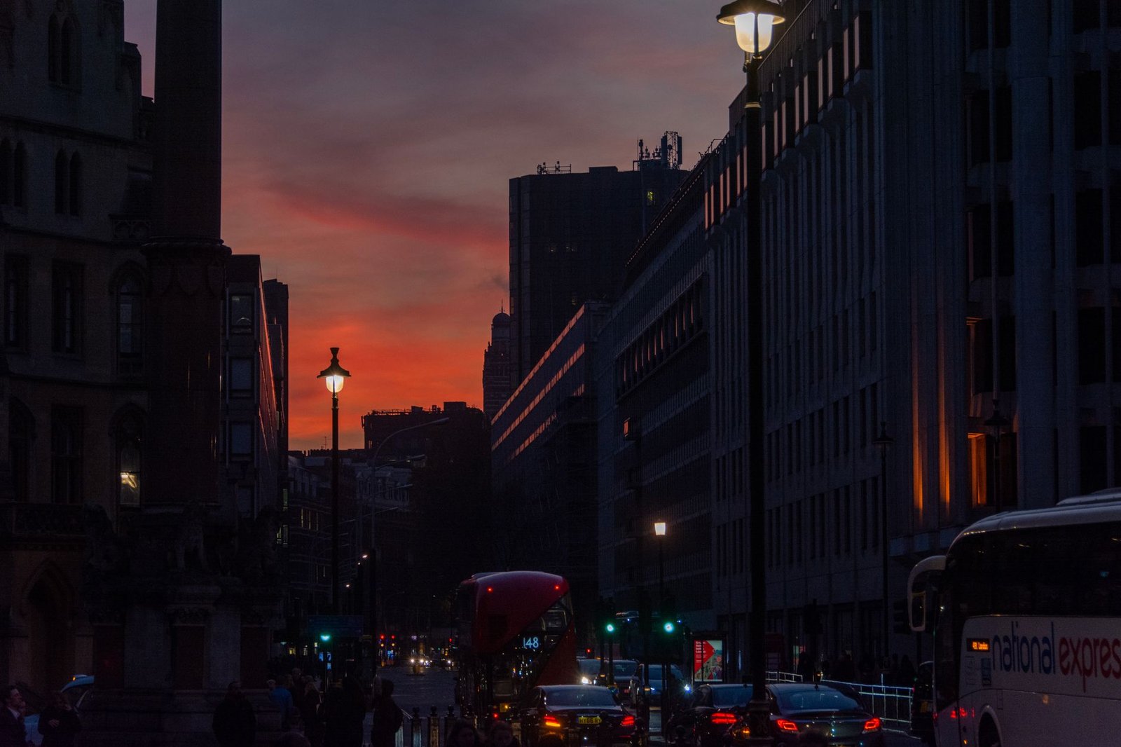 Dynamic urban twilight scene capturing busy London street life with iconic architecture.