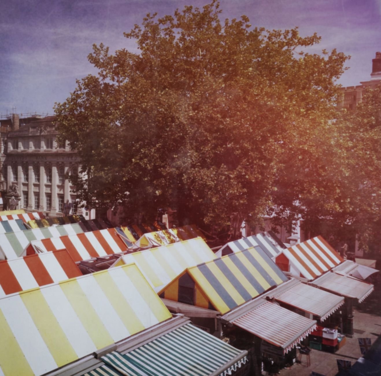 Colorful canopy-covered market stalls in Norwich city center.