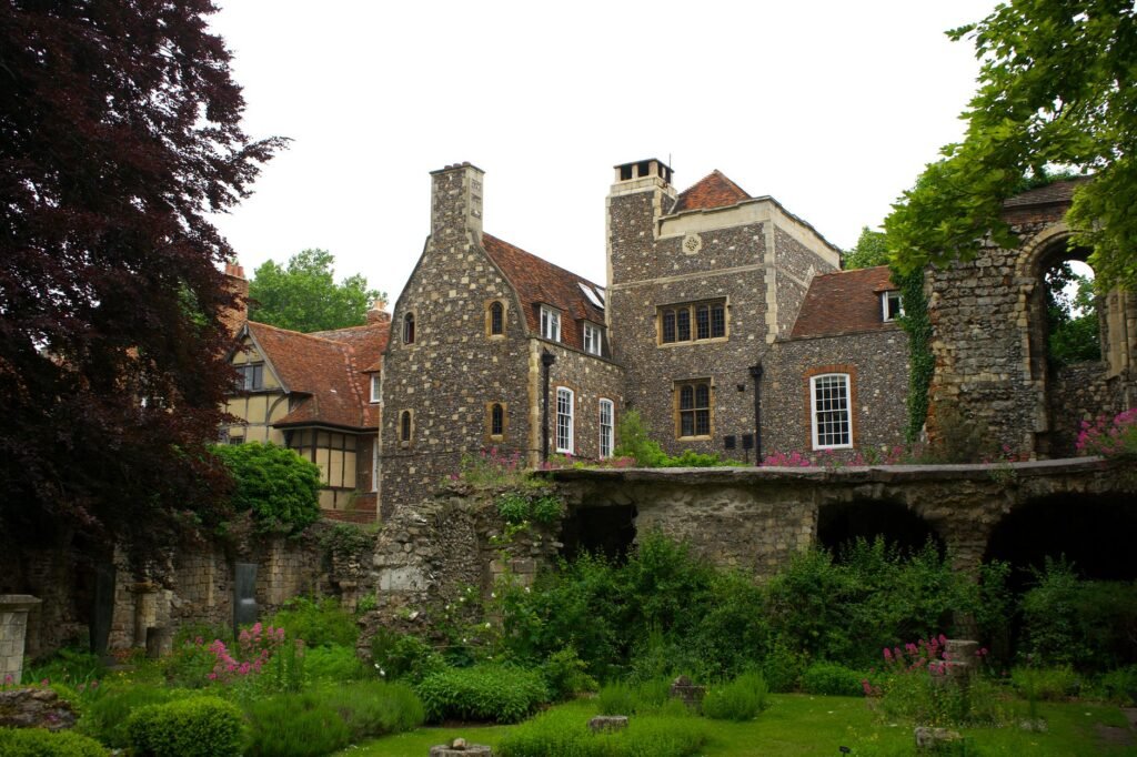 Charming view of historic architecture and lush gardens in Canterbury, England.