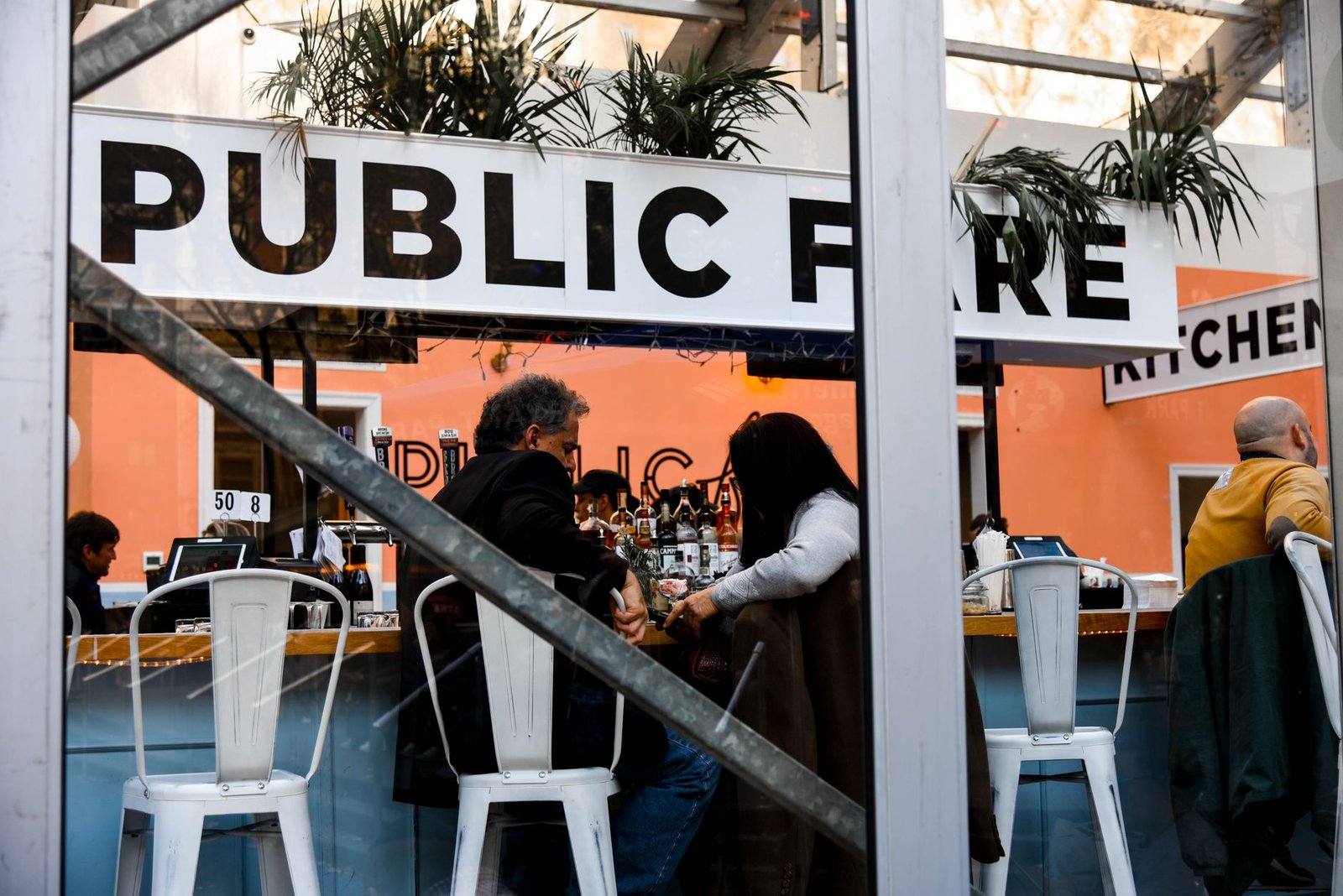People socializing in a modern New York cafe with a trendy interior design.