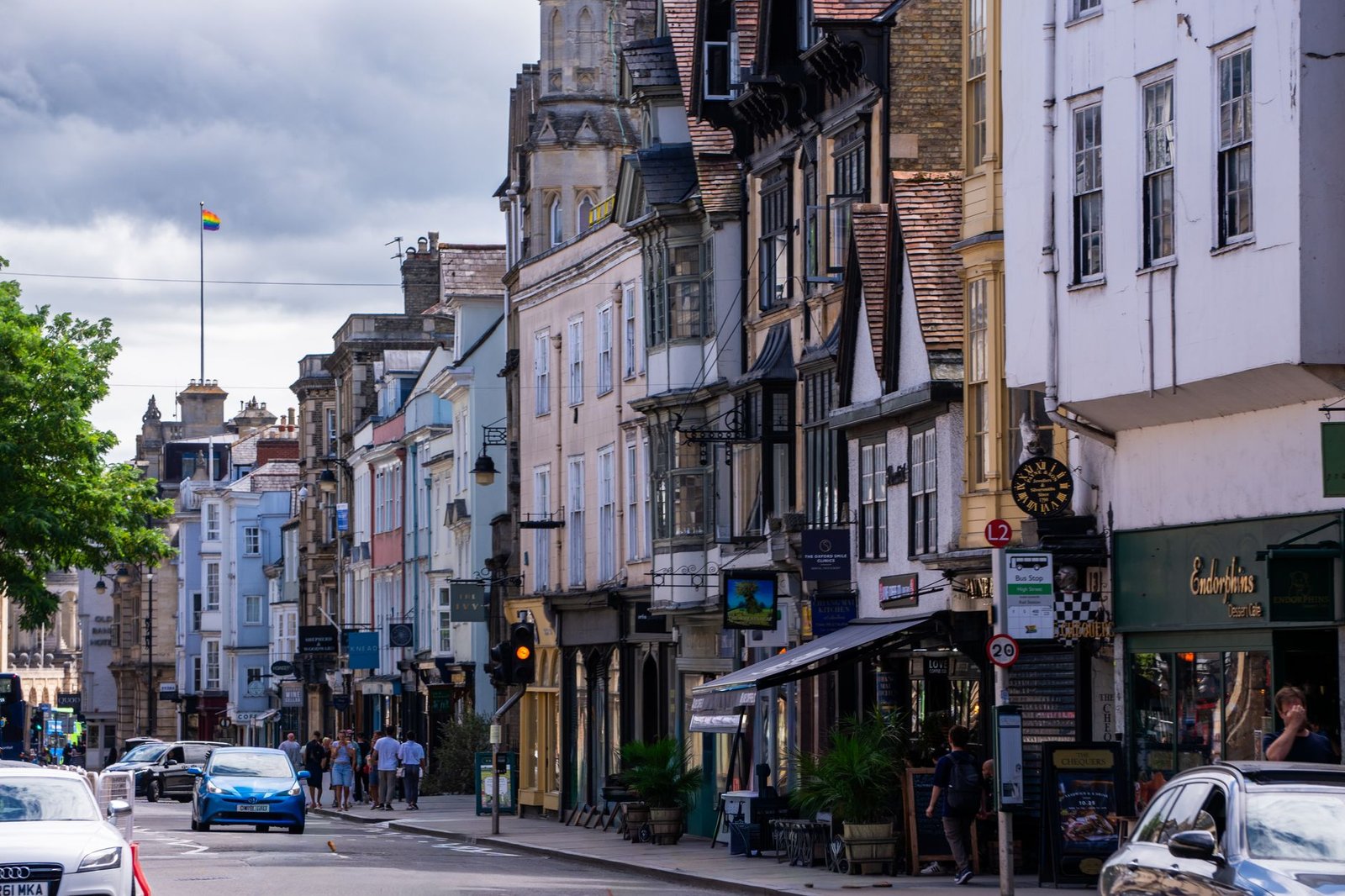 A lively street scene in historic Oxford, England, with classic architecture and vibrant activity.