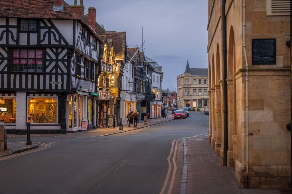 Visitor walking through a well-lit Norwich street