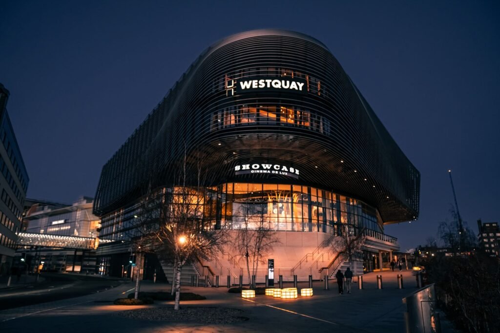 Illuminated night view of Westquay Shopping Centre in Southampton, showcasing urban architecture.