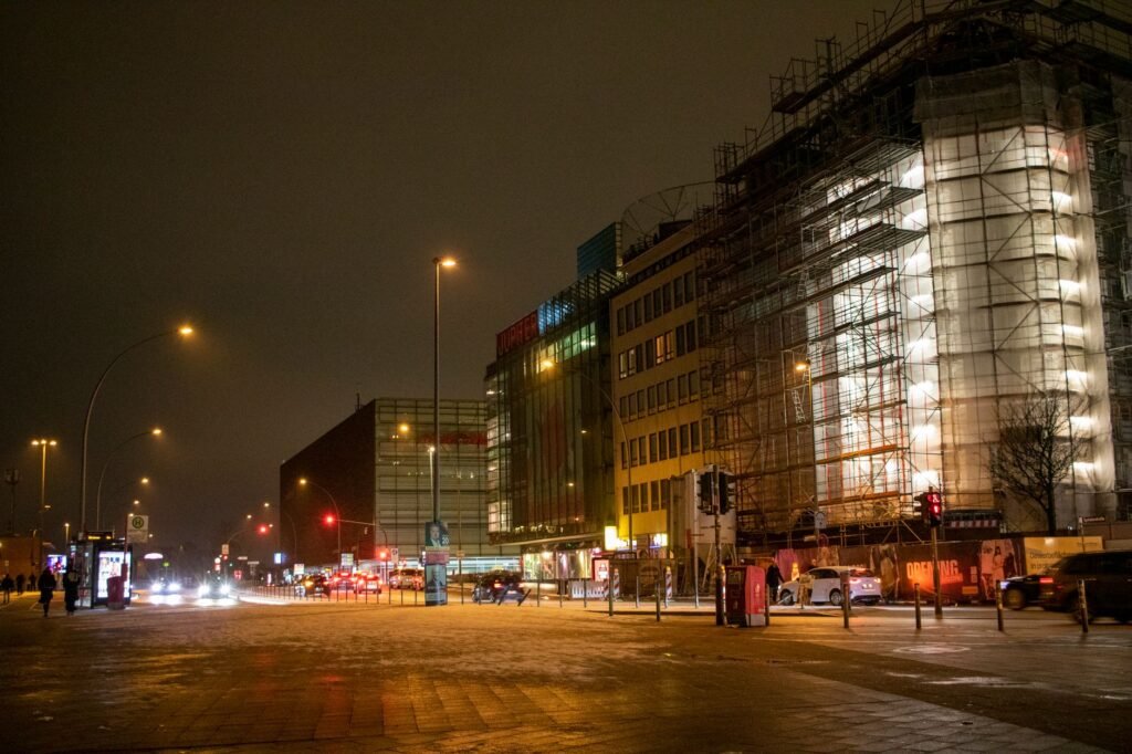 Vibrant night scene in downtown Hamburg, showcasing lit buildings and busy streets.