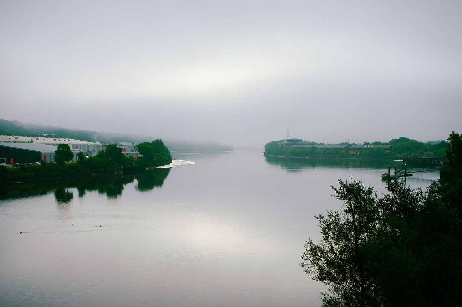 A foggy morning view of the tranquil River Tyne in Newcastle upon Tyne, England.