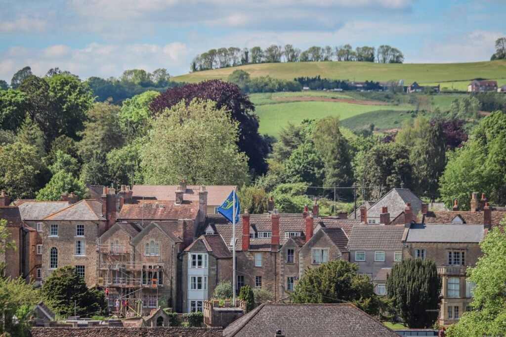Picturesque townhouses in Burton, England, surrounded by lush greenery.