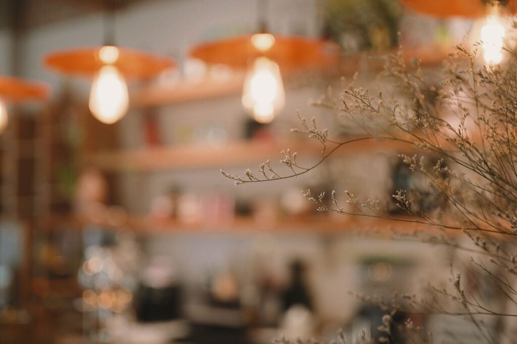 Warm and cozy cafe interior featuring soft focus lighting and decorative twigs.