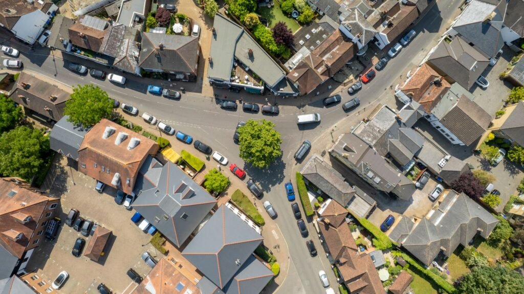 A bird's eye view of Thames Ditton's urban street layout with parked cars, rooftops, and trees.
