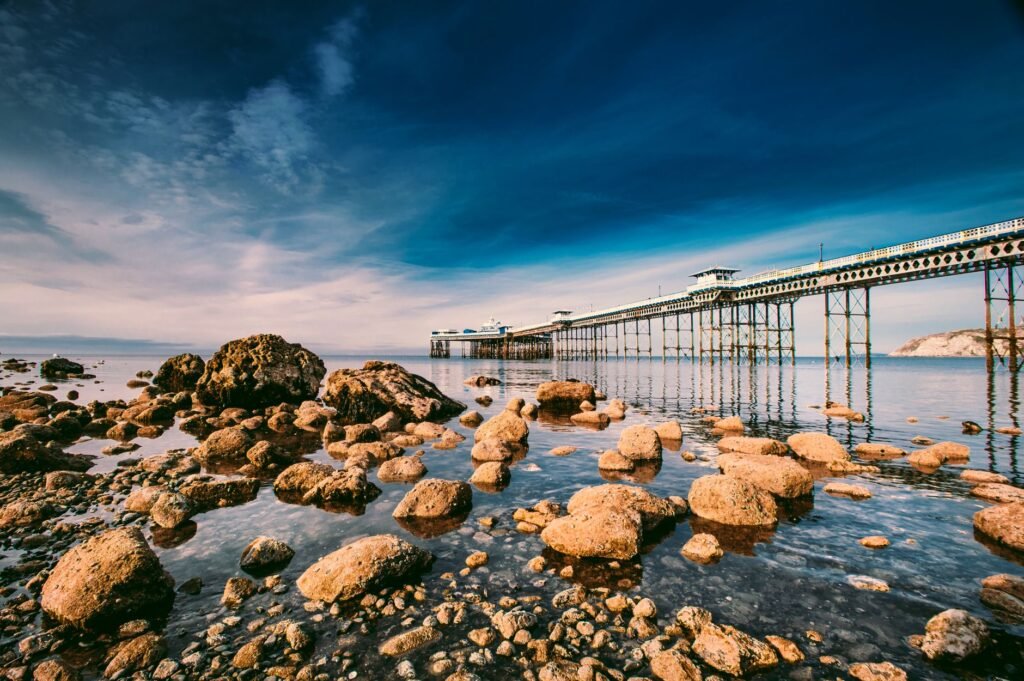 Beautiful seascape featuring Llandudno Pier under a dramatic sky in Wales.