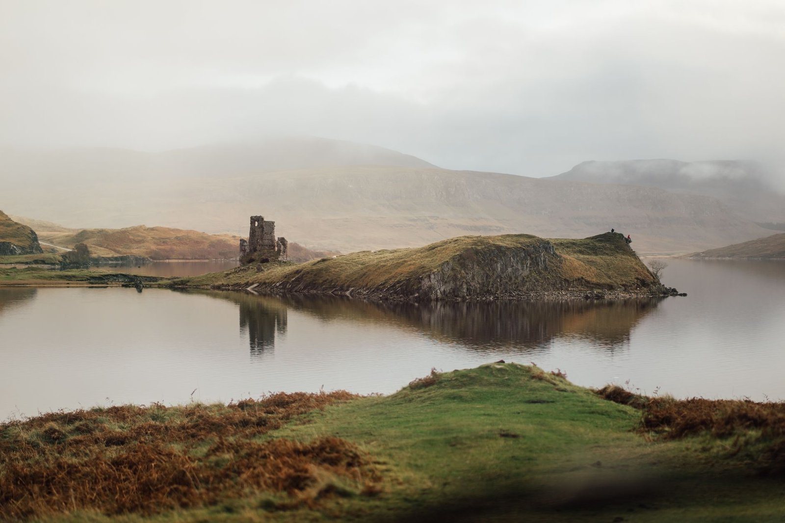 Captivating landscape of Ardvreck Castle on a misty lake in Scotland.