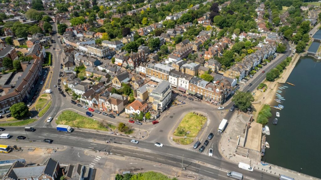 Aerial view of Molesey, England showcasing urban landscape and streets on a sunny day.