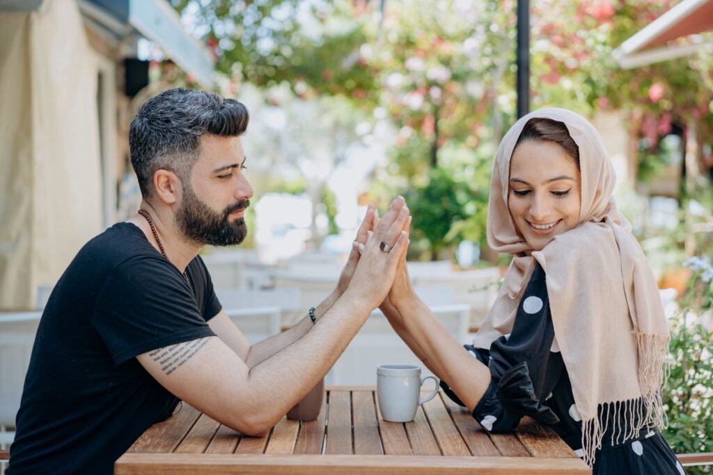 Happy couple with coffee, showing affection at a charming outdoor café