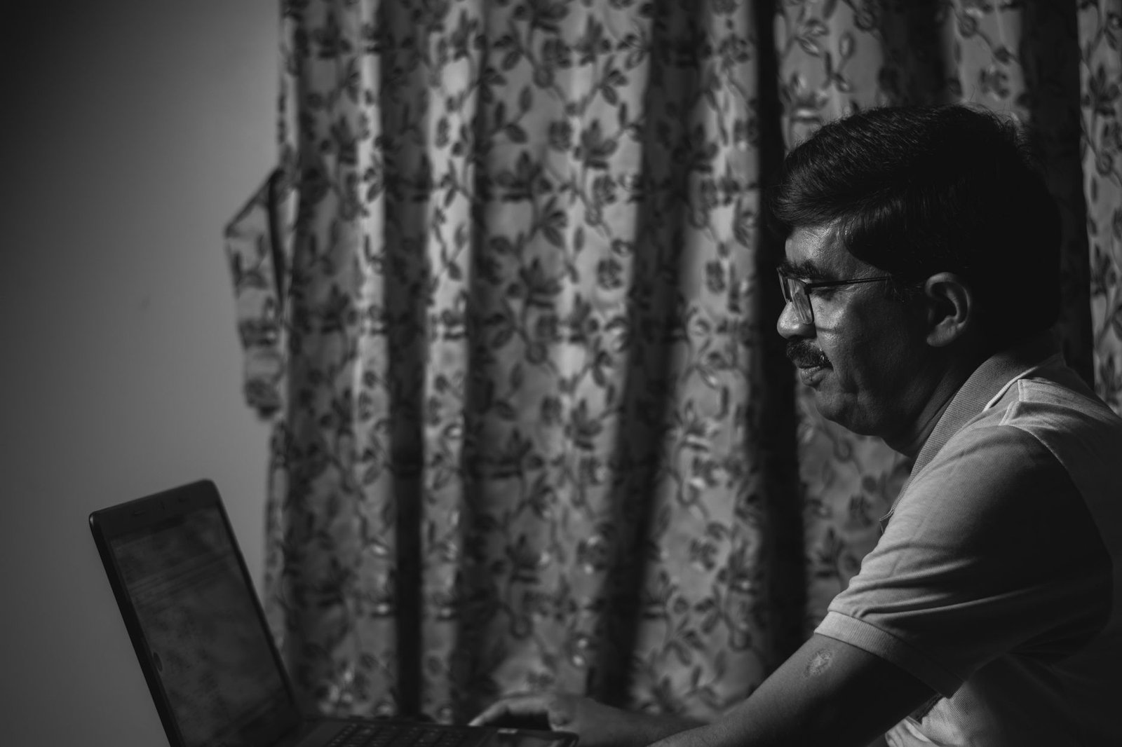 Adult reviewing an online profile on a laptop