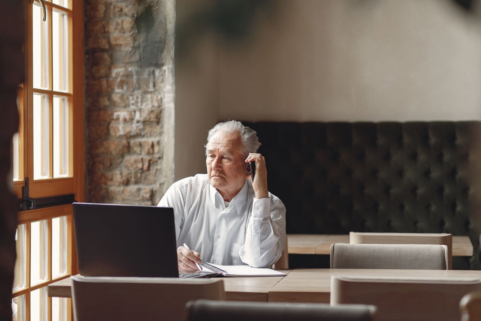 Adult man reviewing a message on his phone in a quiet café