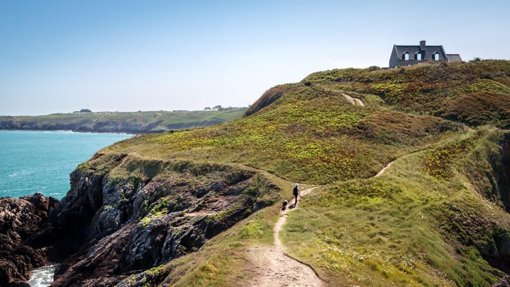 cliffs, house, trail, path, human, pet, dog, walking, trekking, hiking, trek, hike, mountain house, animal, sea, ocean, mount