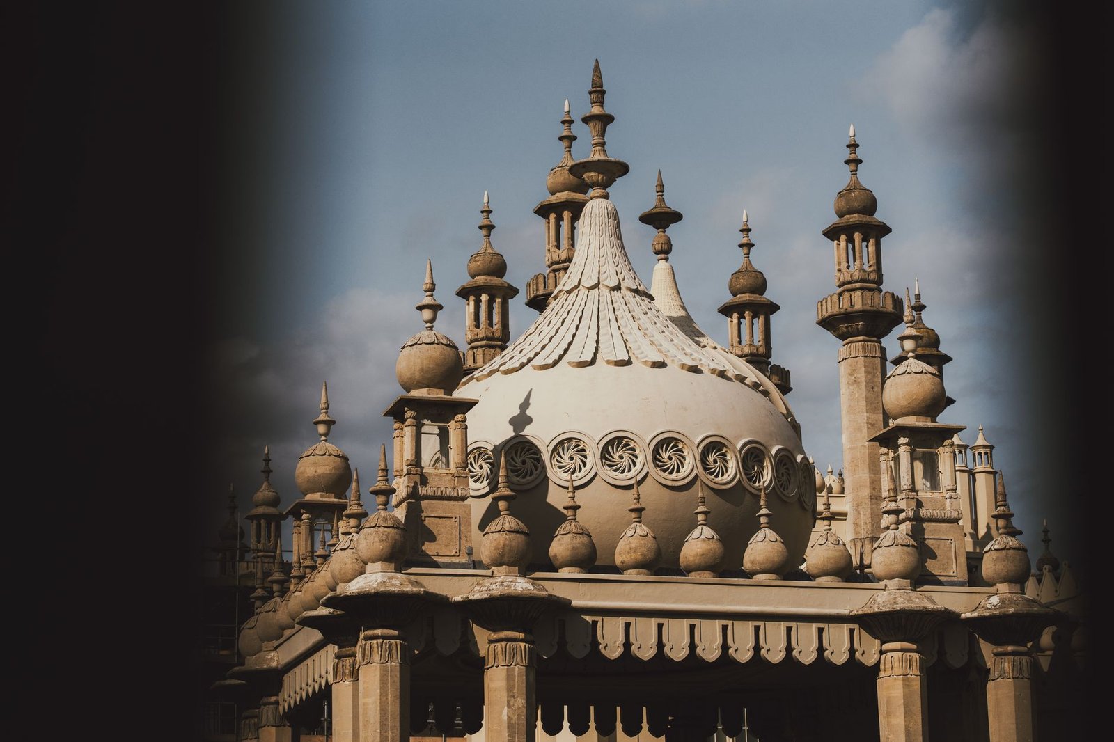 A detailed view of Brighton's Royal Pavilion showcasing ornate architecture under a clear sky.
