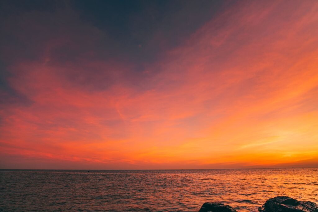 Vibrant sunset over the ocean with colorful sky in Quảng Trị, Vietnam, creating a serene and picturesque seascape.