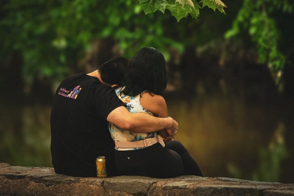 A couple sharing a quiet moment by the riverbank in Washington, DC.