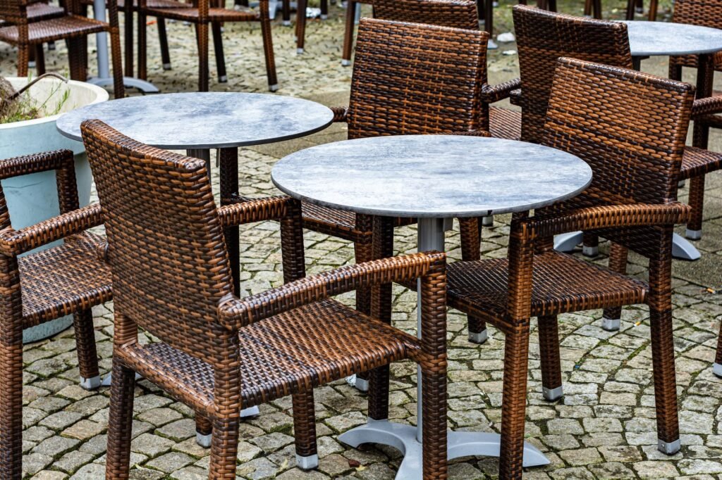 Charming outdoor café scene with wicker chairs and round tables in Coesfeld, Germany.