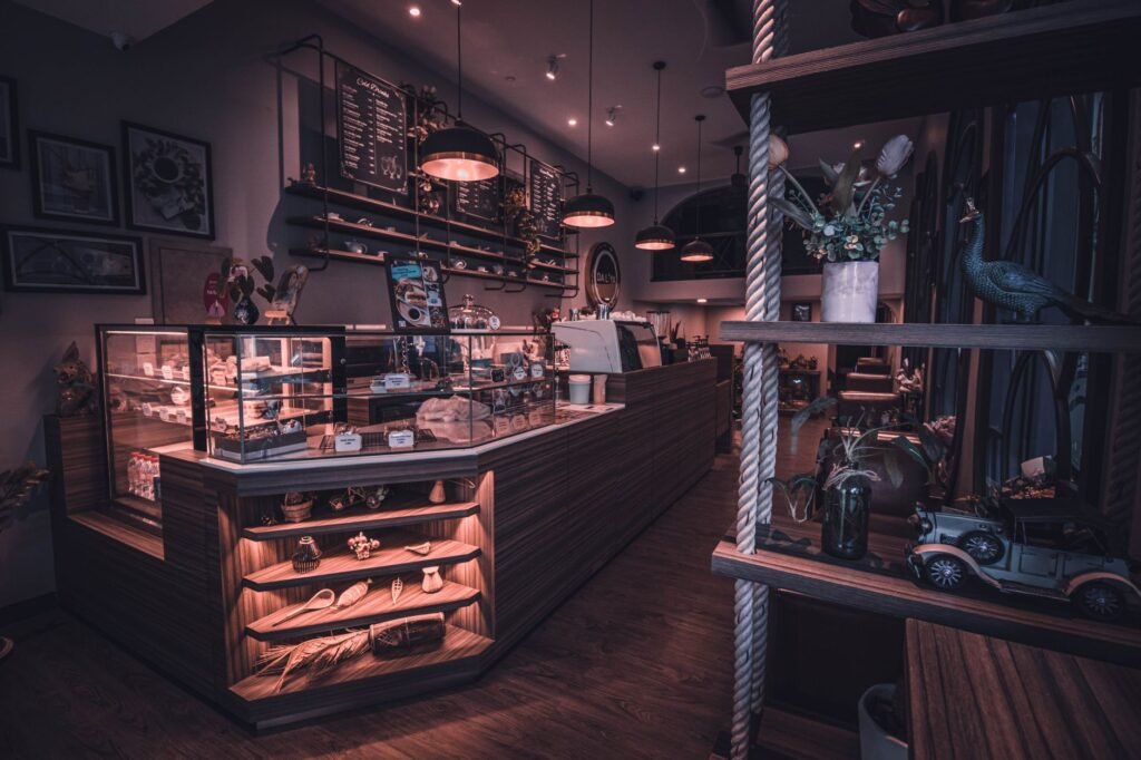 A cozy and stylish coffee shop interior in Phnom Penh featuring warm lighting and elegant furniture.